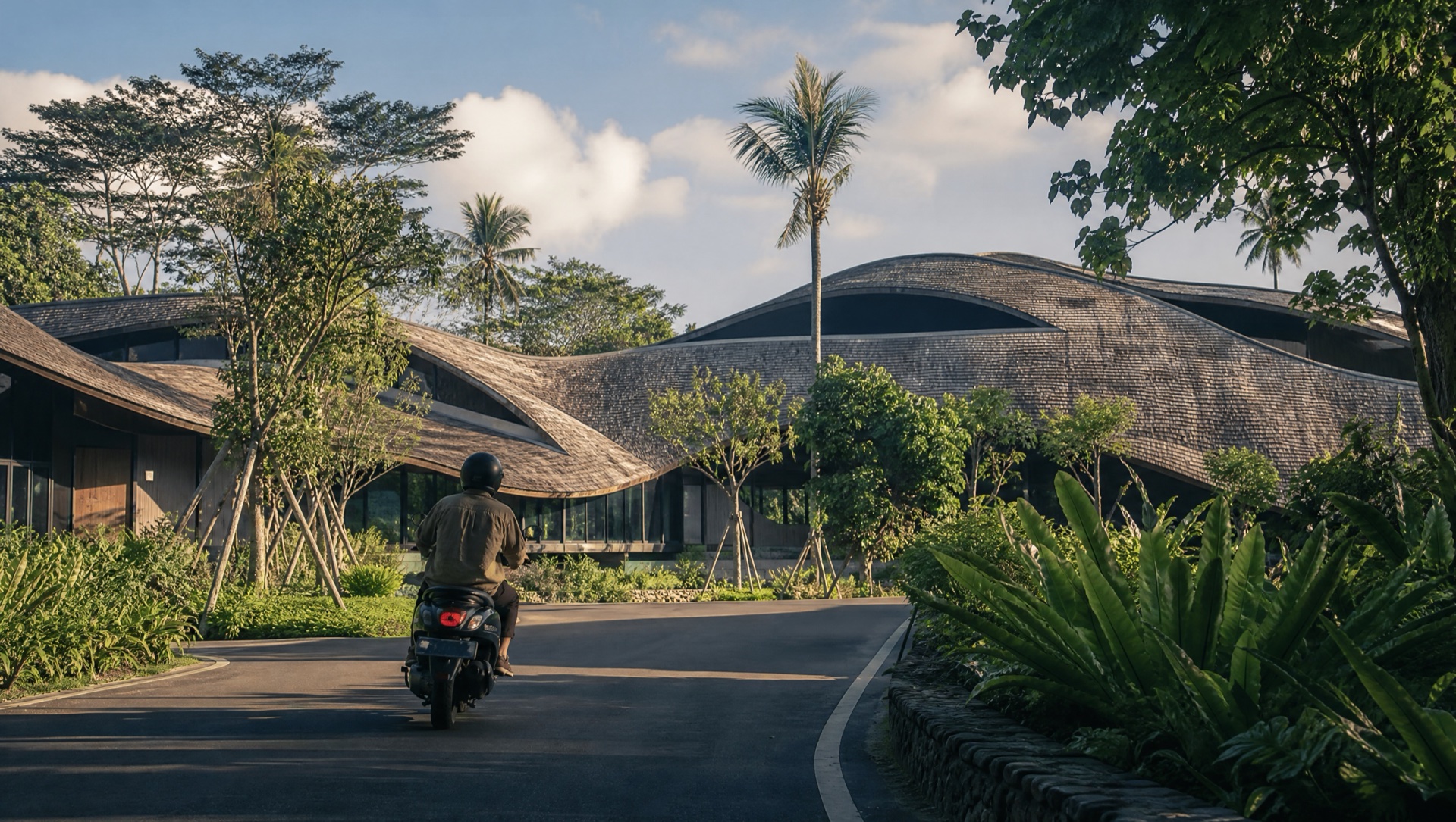 Bali west coast with palms, ocean and a subtle beachfront development at late afternoon